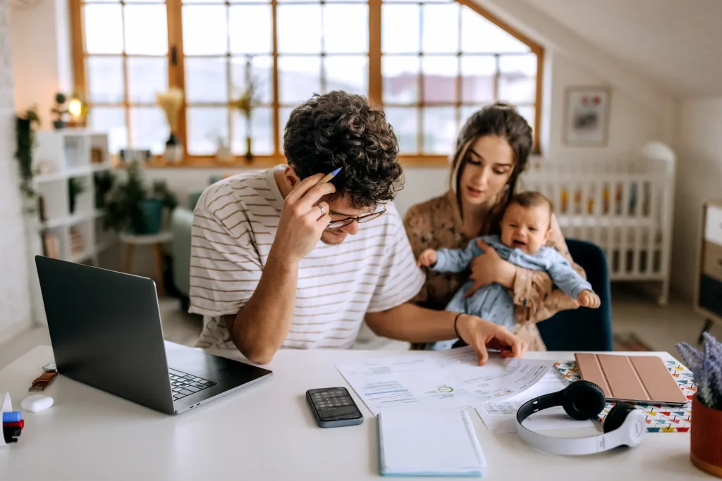 How Children Impact a Relationship: Struggles, Insights, and Strategies Young couple with a baby dealing with stressors of a becoming parents.