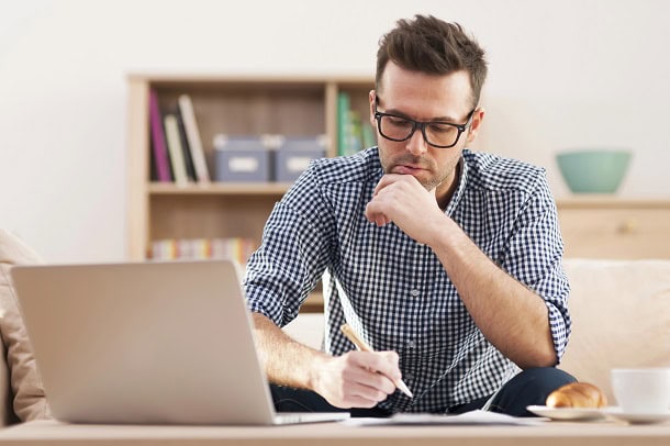 165 Work Quotes of the Day for Daily Motivation, Positive Energy and Success A man looking focused and working in his office.